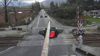 Chilliwack - Chilliwack › West: Highway 7 at Deroche Road and Nicomen Road railway crossing, looking west